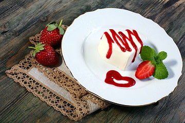 Image showing Panna cotta with cherry sauce.