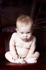 Image showing Child sitting on a armchair