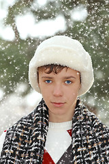 Image showing Handsome teen boy in white fur hat