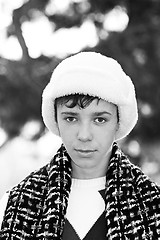Image showing Handsome teen boy in white fur hat