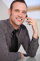 Image showing A business man talking on his smartphone
