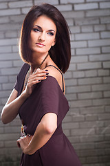 Image showing beautiful girl posing against brick wall