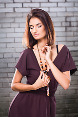 Image showing sensual girl posing against brick wall