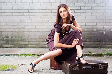 Image showing beautiful lady with vintage suitcase waiting at the station