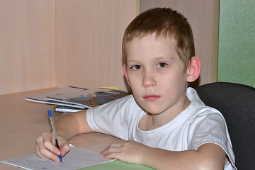 Image showing The boy does homework