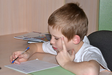 Image showing The boy does homework