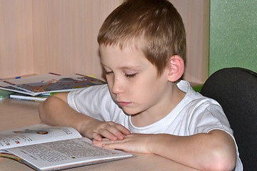 Image showing The boy does homework