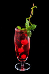 Image showing Alcohol red drink, cocktail with mint, cherry, isolated black