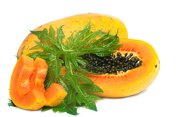 Image showing Ripe papaya and slices with seeds and green leaf isolated on a w