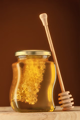 Image showing Glass of honey with honeycomb