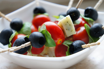 Image showing Olives and cherry tomatoes on the stick