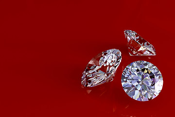 Image showing Three diamonds on red glossy background