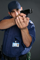 Image showing Security Officer takes aim