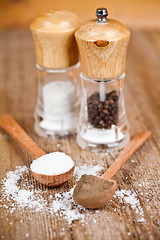 Image showing salt and pepper in spoons and shakers