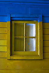 Image showing old yellow window in blue wall 