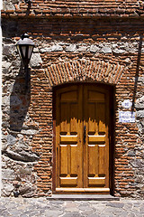 Image showing brown wood old door and a street lamp