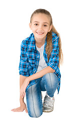 Image showing The girl in jeans and a checkered shirt