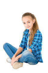 Image showing The girl in jeans and a checkered shirt