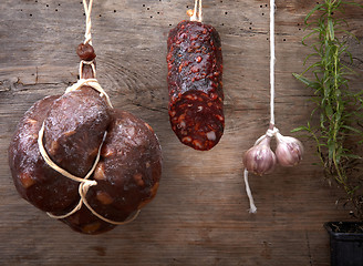 Image showing various hanging salami sausages