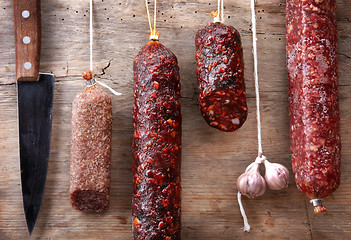 Image showing various hanging salami sausages