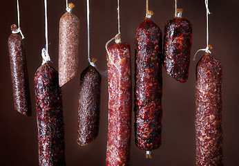 Image showing various hanging salami sausages