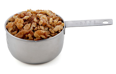 Image showing Chopped walnuts presented in an American metal cup measure