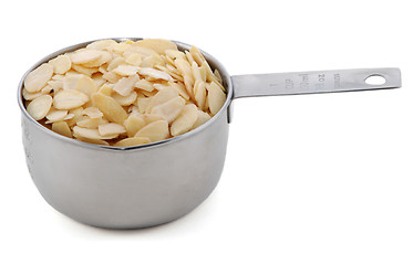 Image showing Flaked almonds presented in an American metal cup measure