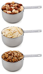 Image showing Whole hazelnuts, flaked almonds and chopped walnuts in cup measures