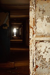 Image showing Dark corridor with painted door