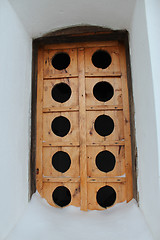 Image showing Ancient wooden window in a wall