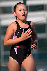 Image showing Young female triatlete running