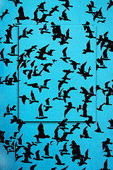 Image showing Set of silhouettes of birds on a blue background