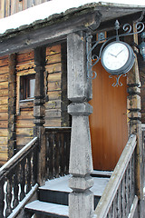 Image showing Wooden porch of the wooden house with clock