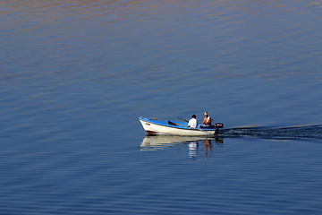 Image showing Fisherman in boat sailing out