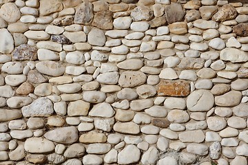 Image showing Texture of stone wall built of irregular pebbles 