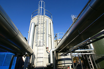 Image showing Industrial zone, Steel pipelines and valves against blue sky