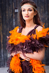 Image showing girl in brown and orange boa