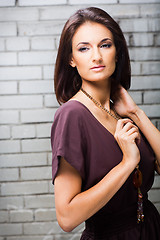 Image showing beautiful girl posing against brick wall