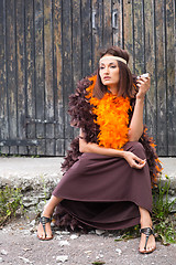 Image showing smoking actress in brown and orange boa