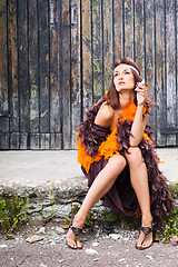 Image showing smoking actress in brown and orange boa