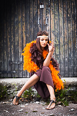 Image showing smoking actress in brown and orange boa