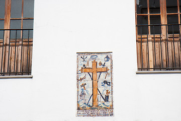 Image showing Earthenware cross on a white facade.