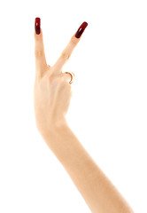 Image showing hand with long acrylic nails showing victory sign