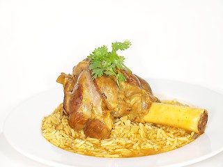 Image showing Lamb shank in juicy yellow rice