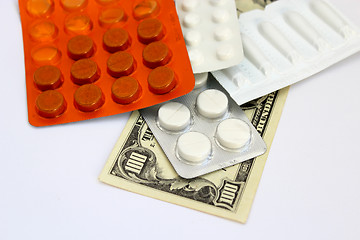 Image showing Packings with pills and dollars