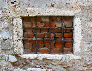 Image showing Old window blocked with grates and bricks