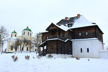 Image showing the wooden house and beautiful church in winter