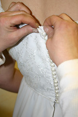 Image showing Buttoning the Bride