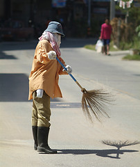 Image showing Woman sweeping the street