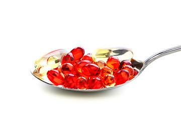 Image showing Colored capsules with vitamins in a spoonful.